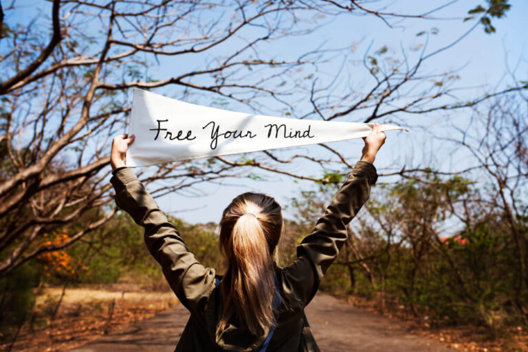 Person relaxing outdoors, embracing a mindful moment and slowing down