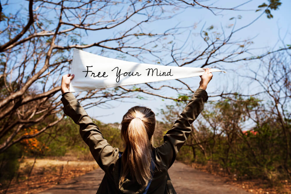 Person relaxing outdoors, embracing a mindful moment and slowing down
